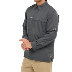 Man wearing dark gray long-sleeve fishing shirt with button front and utility loop on sleeve.