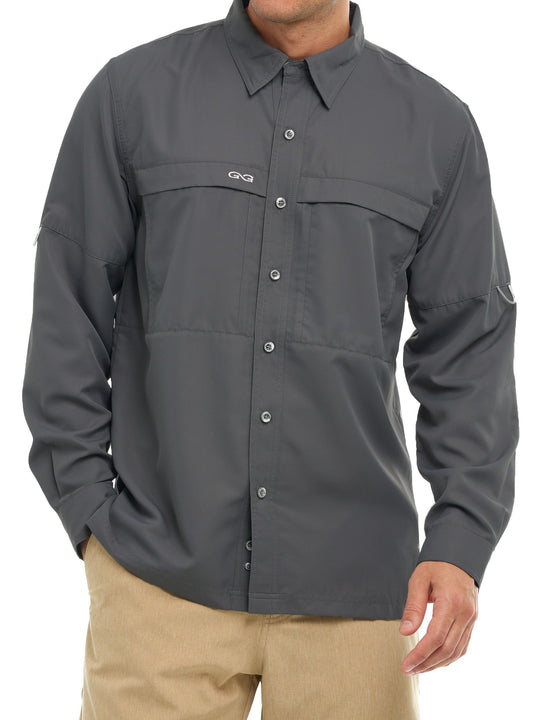Man wearing a dark gray long-sleeve outdoor button-up shirt with tan pants against white background.