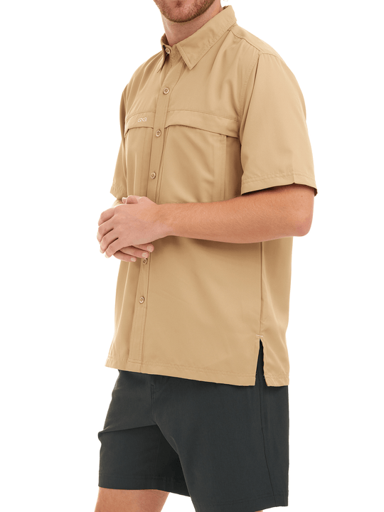 Man wearing khaki short-sleeve shirt and black shorts on a white background