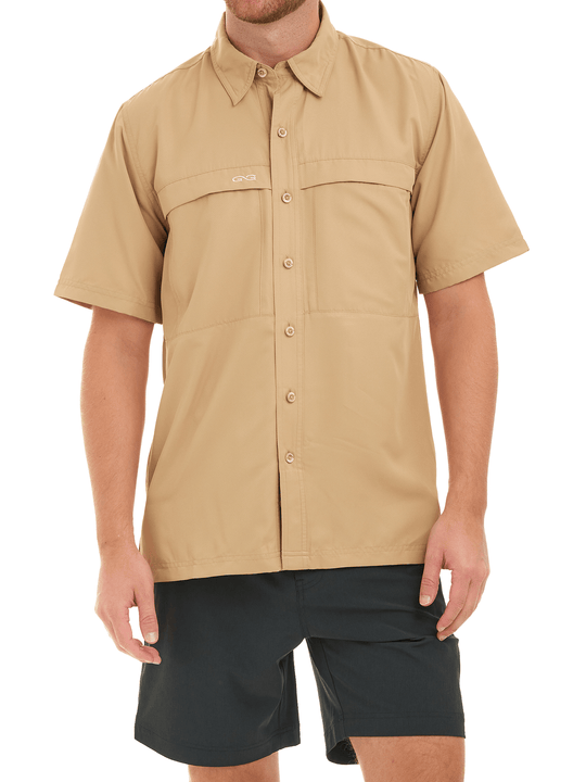 Man wearing a khaki short-sleeve shirt with button details on a white background