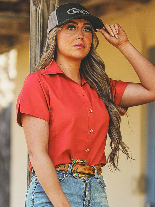 Lava Rock Ladies Original Shirt-GameGuard - Lady standing on the porch enjoying the outdoors while also wearing a Juniper Cap.