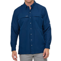 Man wearing Deep Water blue GameGuard Original long sleeve shirt with mesh vents, roll-up sleeves, GG logos, and utility loop; made for fishing and sun protection.