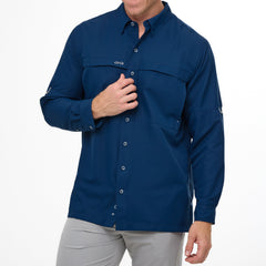 Man wearing Deep Water blue GameGuard Original long sleeve shirt with mesh vents, roll-up sleeves, GG logos, and utility loop; made for fishing and sun protection.