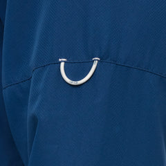 Man wearing Deep Water blue GameGuard Original long sleeve shirt with mesh vents, roll-up sleeves, GG logos, and utility loop; made for fishing and sun protection.