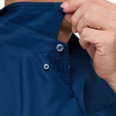 Man wearing Deep Water blue GameGuard Original long sleeve shirt with mesh vents, roll-up sleeves, GG logos, and utility loop; made for fishing and sun protection.
