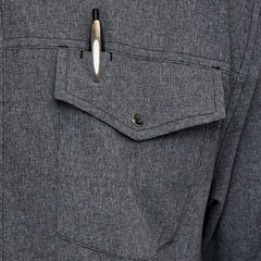 Man wearing Caviar GameGuard Pearl Snap Shirt with long sleeves, flap chest pockets, snap closures, and western yoke; classic rugged style for ranch or town.