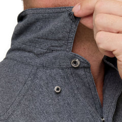 Man wearing Caviar GameGuard Pearl Snap Shirt with long sleeves, flap chest pockets, snap closures, and western yoke; classic rugged style for ranch or town.